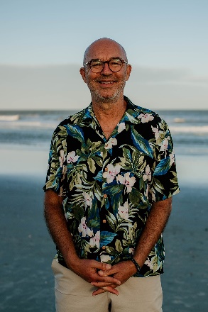 A person in a hawaiian shirtDescription automatically generated